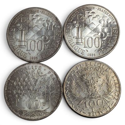 four different types of coins are shown on a white surface