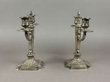 pair of silver candlesticks with angels on each of them
