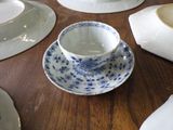 many plates and cups sitting on a table with napkins