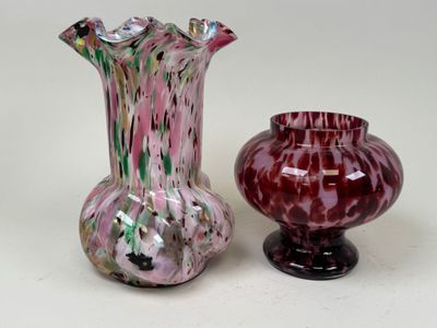 two vases sitting next to each other on a table