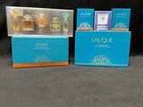 two boxes of perfume are sitting next to each other on a table