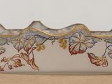 a close up of a glass bowl with flowers on it