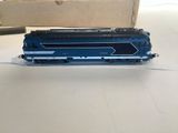 a toy train on a table with a box in the background