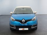 the front of a blue car in a room with a white wall