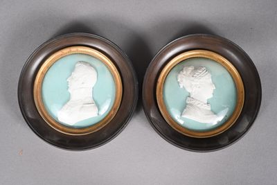 pair of wednestone portraits of a man and a woman