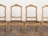 six chairs in a row in a room with a wall in the background