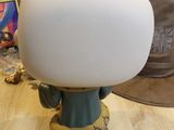 a lamp that is sitting on a table next to a hat