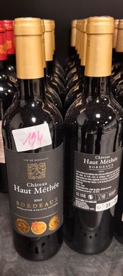 several bottles of wine are lined up on a shelf
