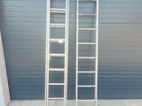 two ladders that are leaning against a garage door