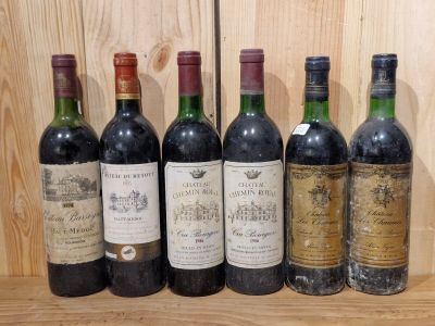 six bottles of wine are lined up on a shelf in front of a wooden wall