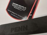 a close up of a pair of scissors next to a bottle of penn