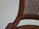 the back of a cane cane chair with a wooden frame and wicker seat