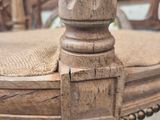 a close up of a wooden chair with a lace on it