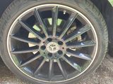 a close up of a car tire on a dirt road