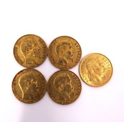 five gold coins of different sizes and shapes on a white surface