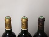 three bottles of wine sitting on a table next to each other
