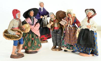 five figurines of people dressed in traditional clothing
