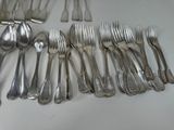 a lot of spoons and forks laid out on the table