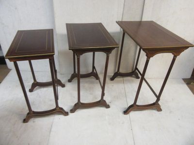 three small tables are sitting next to each other on a white floor