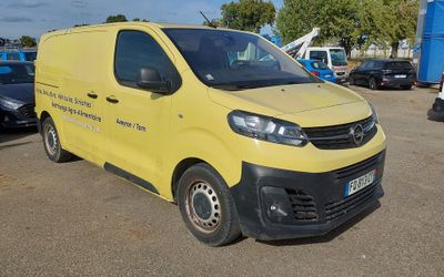 a yellow van that is parked in a parking lot