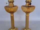 pair of antique brass candlesticks on pedestals with black marble top