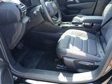 the interior of a car with the door open showing the driver ' s seat