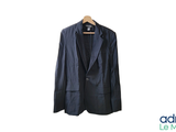 a black jacket hanging on a hanger on a white wall