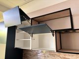 a black and white kitchen with a sink and cabinets