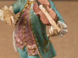 a figurine of a man playing a violin