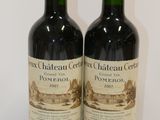 two bottles of wine sitting on top of a table next to each other