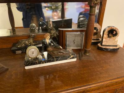 a wooden dresser with a mirror and a clock on top of it