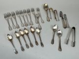 a lot of spoons and forks laid out on the table