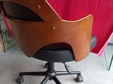 a chair that has a wooden seat on it