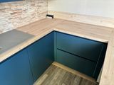 a kitchen with a sink and a counter top in it