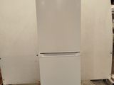 a white refrigerator sitting on a pallet in a warehouse