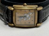 a wrist watch with a horse on it on a table