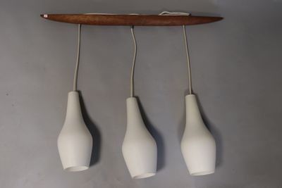 three white vases hanging from the ceiling of a room