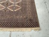 a rug on the floor with a cat sitting on top of it
