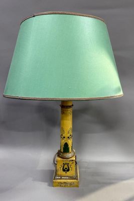 yellow and green table lamp with a green shade on top of it