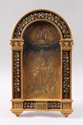 an image of a gold - plated statue of a man and a woman on a cross