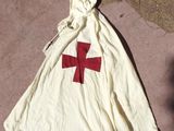 a bag with a red cross on it sitting on the ground