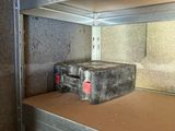 a metal shelf with a tool box on top of it