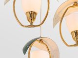three gold and white glass lamps hanging from a ceiling