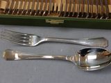 a green box with silverware in it and a fork and spoon