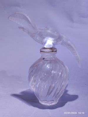 a clear glass bottle with a bird on it