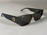 black sunglasses with a gold logo on the side of the glasses