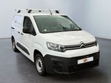 the white van is parked in a large room with a black floor