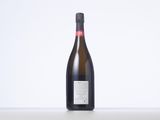 a bottle of wine sitting on top of a white table