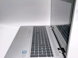 a silver laptop with a blue sticker on the screen