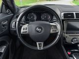 the interior of a car with a steering wheel and dashboard controls